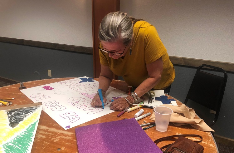 Deb Cole making a poster for the 5 NEPP Climbers CAO 22