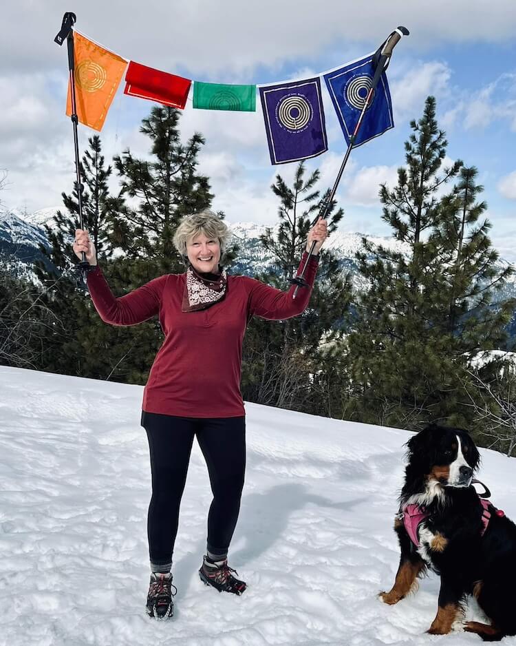 Dana at summit with prayer flags