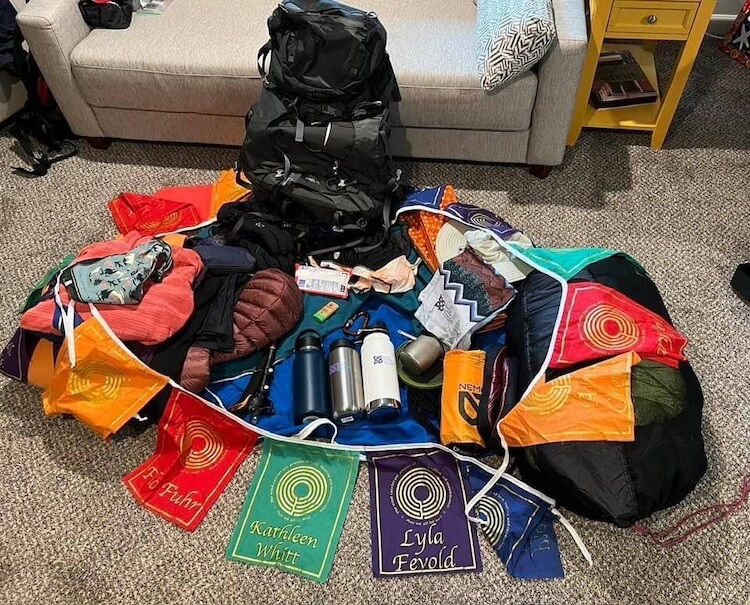 Dana's mountain climbing pack and contents with prayer flags