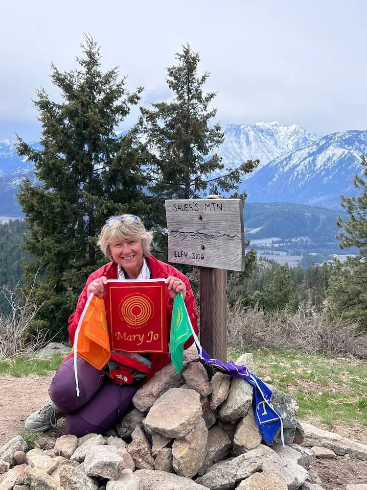 Dana at the summit with prayer flags