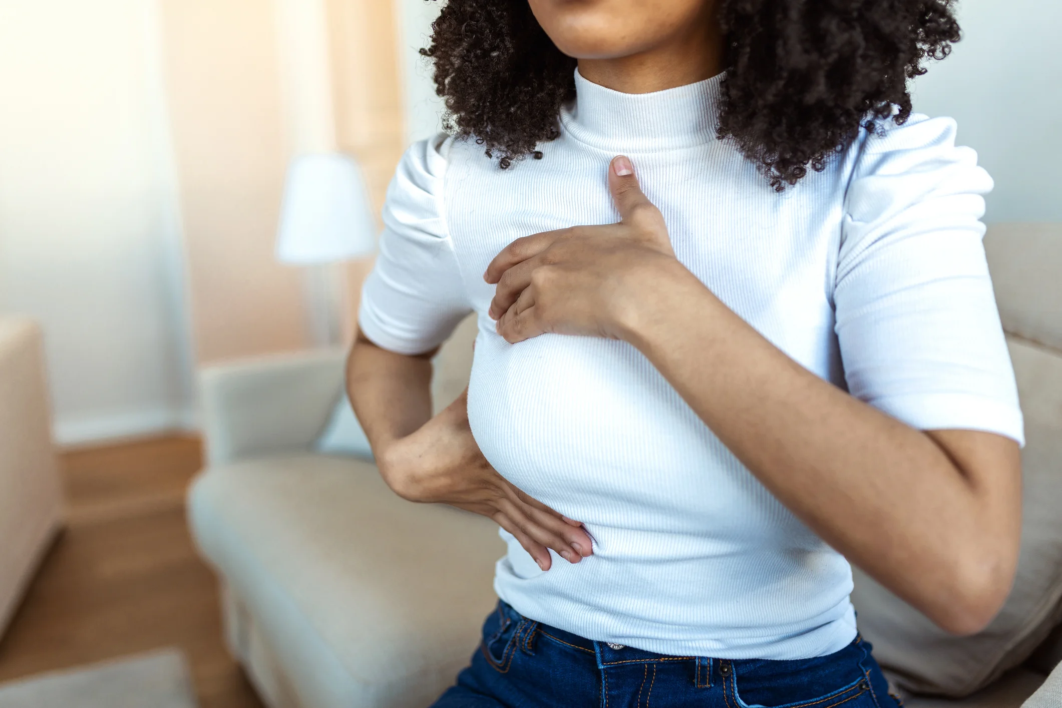 African-American-Woman-hand-checking-lumps-on-her-breast-for-signs-of-breast-cancer